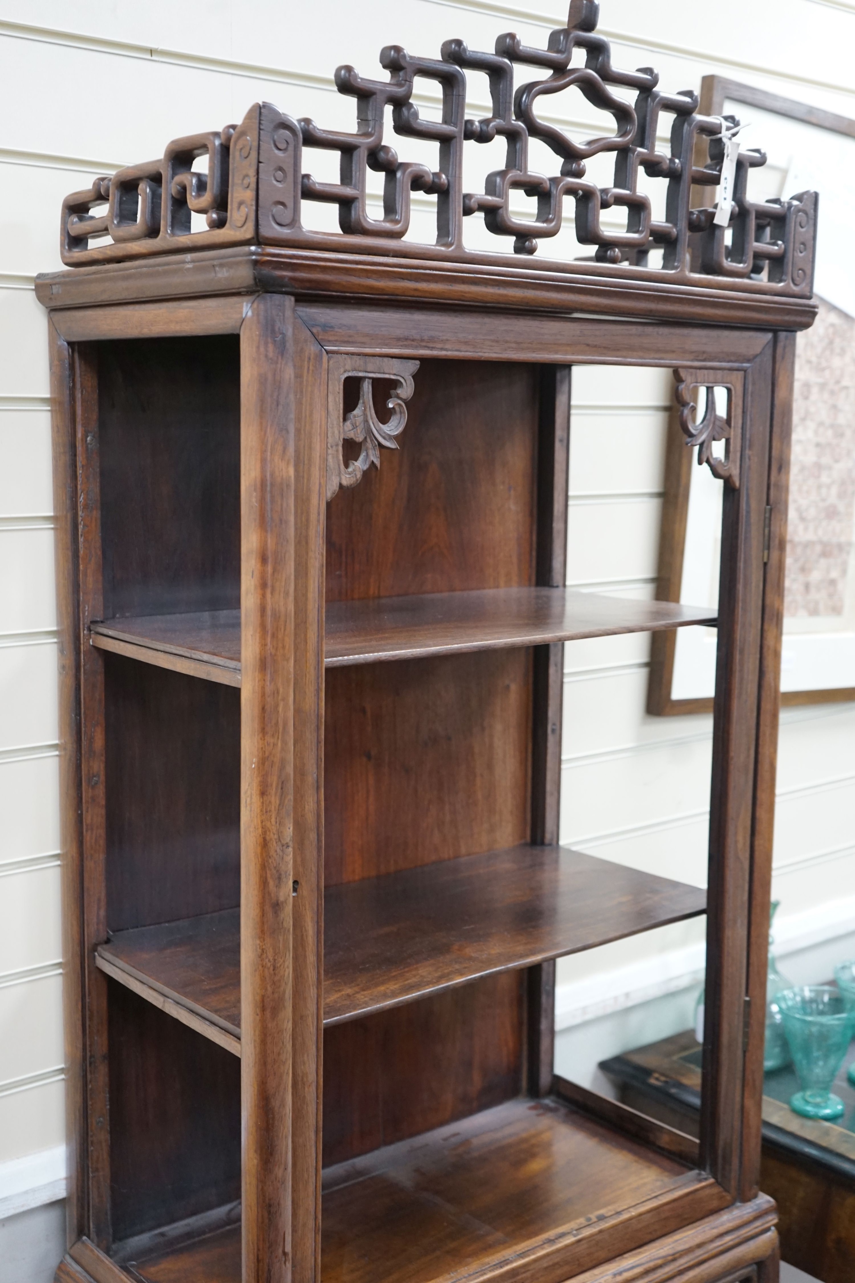 A Chinese hongmu cabinet on stand , circa 1900, lacking glazing, width 63cm, depth 35cm, height 185cm